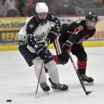Soldotnas Keegan Myrick shields the puck from Kenai Centrals Everett Chamberlain on Friday, Feb. 7, 2025, at the First National Cup Division II state hockey tournament at the Soldotna Regional Sports Complex in Soldotna, Alaska. (Photo by Jeff Helminiak/Peninsula Clarion)