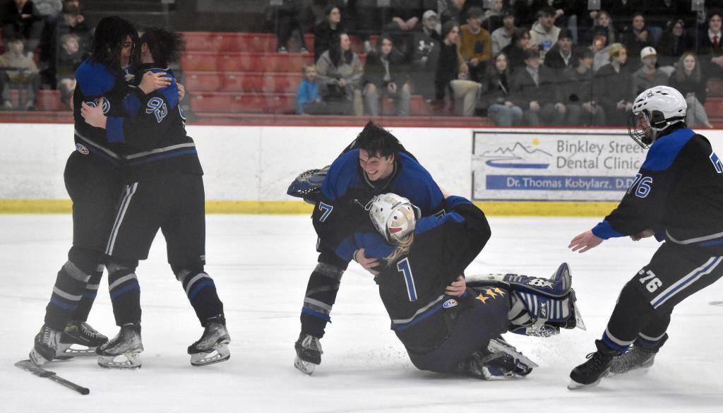 Palmer mobs goalie Emily Christman after defeating Soldotna for the championship at the First National Cup Division II state hockey tournament Saturday, February 8, 2025, at the Soldotna Regional Sports Complex in Soldotna, Alaska. (Photo by Jeff Helminiak/Peninsula Clarion)