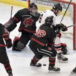 Kenai Centrals Sawyer Vann and Elliot Welch of Juneau-Douglas battle for the puck in front of Juneau goalie Caleb Friend at the First National Cup Division II state hockey tournament Saturday, February 8, 2025, at the Soldotna Regional Sports Complex in Soldotna, Alaska. (Photo by Jeff Helminiak/Peninsula Clarion)
