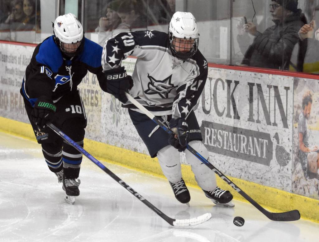 Soldotnas Peter Perez-Bailon carries the puck against Palmers Liam Hilscher at the First National Cup Division II state hockey tournament Saturday, February 8, 2025, at the Soldotna Regional Sports Complex in Soldotna, Alaska. (Photo by Jeff Helminiak/Peninsula Clarion)