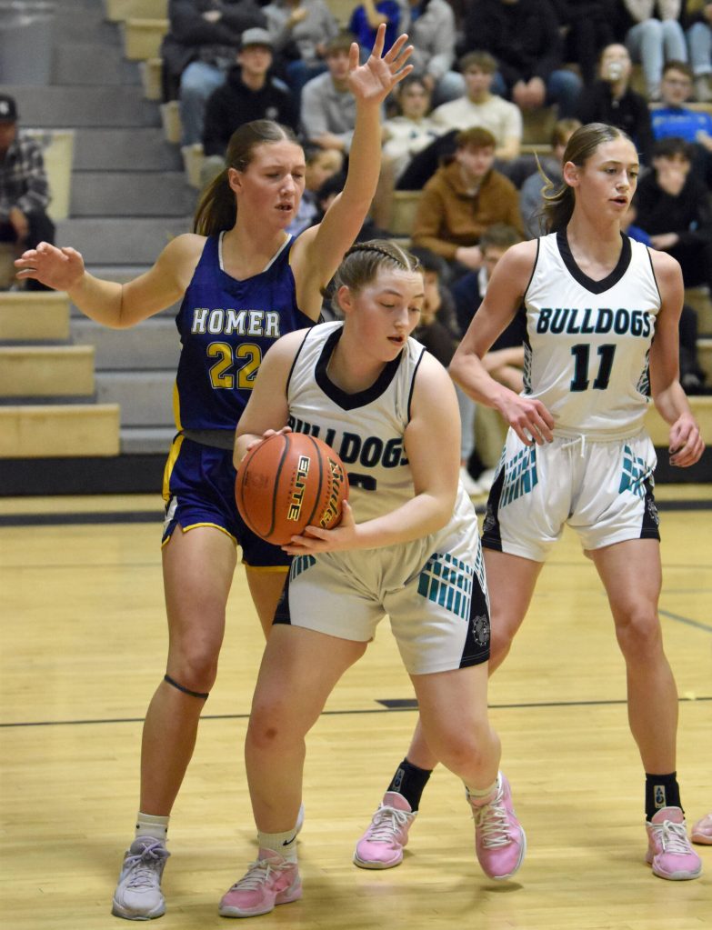 Nikiskis Avery Ellis pulls down a rebound in front of Homers Madalyn Miotke on Tuesday, February 11, 2025, at Nikiski Middle-High School in Nikiski, Alaska. (Photo by Jeff Helminiak/Peninsula Clarion)