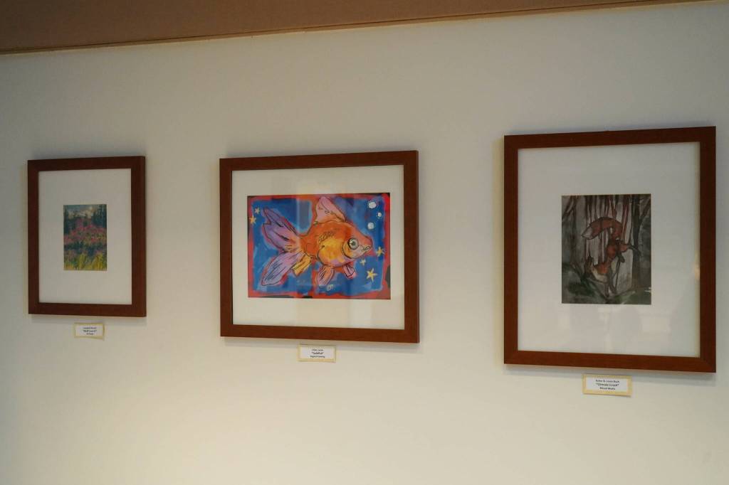 Artwork by Campbell Kincaid, Chloe Jacko and Kylee St. Louis-Bush is seen as part of the inaugural exhibition of Spirit of Soldotna: Showcasing Student Art in Soldotna City Hall in Soldotna, Alaska, on Wednesday, Feb. 12, 2025. (Jake Dye/Peninsula Clarion)