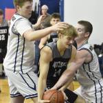 Nikiskis Ethan Ellis is pressured by Ninilchiks Maxx Russell and Brandt Mill at the Keith Presley Memorial Tournament on Friday, February 14, 2025, at Ninilchik School in Ninilchik, Alaska. (Photo by Jeff Helminiak/Peninsula Clarion)