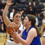 Hadassah Haskins of Nanwalek drives on Maria Smith of Cook Inlet Academy on Saturday, February 15, 2025, at Cook Inlet Academy just outside of Soldotna, Alaska. (Photo by Jeff Helminiak/Peninsula Clarion)