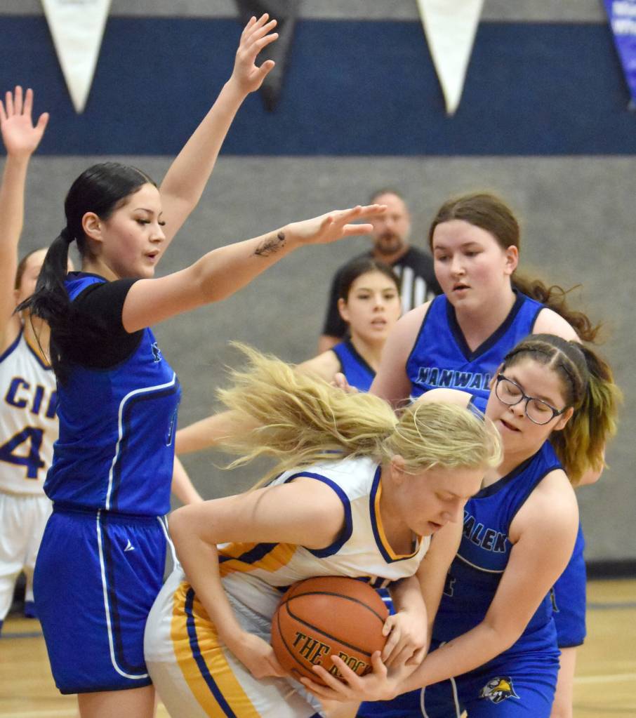 Cook Inlet Academys Brandi Harkleroad battles Phontina Demas and Emma Tanape of Nanwalek for the ball Saturday, February 15, 2025, at Cook Inlet Academy just outside of Soldotna, Alaska. (Photo by Jeff Helminiak/Peninsula Clarion)