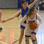 Cook Inlet Academys Serenity Plate holds the ball in front of Nanwaleks Alyson Seville on Saturday, February 15, 2025, at Cook Inlet Academy just outside of Soldotna, Alaska. (Photo by Jeff Helminiak/Peninsula Clarion)