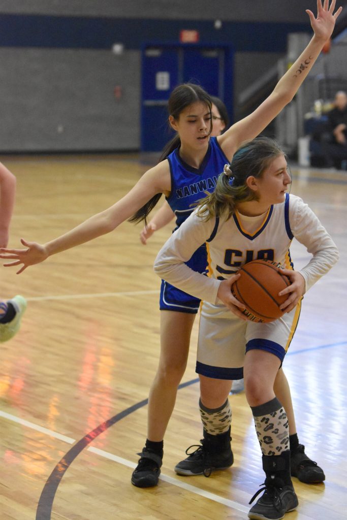 Cook Inlet Academys Serenity Plate holds the ball in front of Nanwaleks Alyson Seville on Saturday, February 15, 2025, at Cook Inlet Academy just outside of Soldotna, Alaska. (Photo by Jeff Helminiak/Peninsula Clarion)
