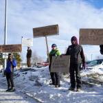 Protesters stand with signs in support of federal employees, federal lands and the U.S. Constitution stand along the Sterling Highway in Soldotna, Alaska, on Monday, Feb. 17, 2025. (Jake Dye/Peninsula Clarion)