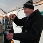 A brewer from King Street Brewing Company pours a cup for an attendee at the 10th Annual Frozen River Fest in Soldotna, Alaska, on Saturday, Feb. 15, 2025. (Jake Dye/Peninsula Clarion)