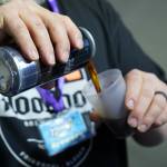 A brewer from HooDoo Brewing Company fills a cup for an attendee at the 10th Annual Frozen River Fest in Soldotna, Alaska, on Saturday, Feb. 15, 2025. (Jake Dye/Peninsula Clarion)