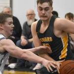 Ninilchik's Brandt Mill tries to steal the ball from Seward's Talon Lemme on Friday, February 21, 2025, at Ninilchik School in Ninilchik, Alaska. (Photo by Jeff Helminiak/Peninsula Clarion)