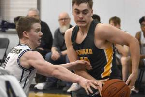 Ninilchik's Brandt Mill tries to steal the ball from Seward's Talon Lemme on Friday, February 21, 2025, at Ninilchik School in Ninilchik, Alaska. (Photo by Jeff Helminiak/Peninsula Clarion)