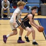 Grace Christians Bensen Malone drives around Soldotnas Liam Peck on Saturday, Feb. 22, 2025, at Soldotna High School in Soldotna, Alaska. (Photo by Jeff Helminiak/Peninsula Clarion)