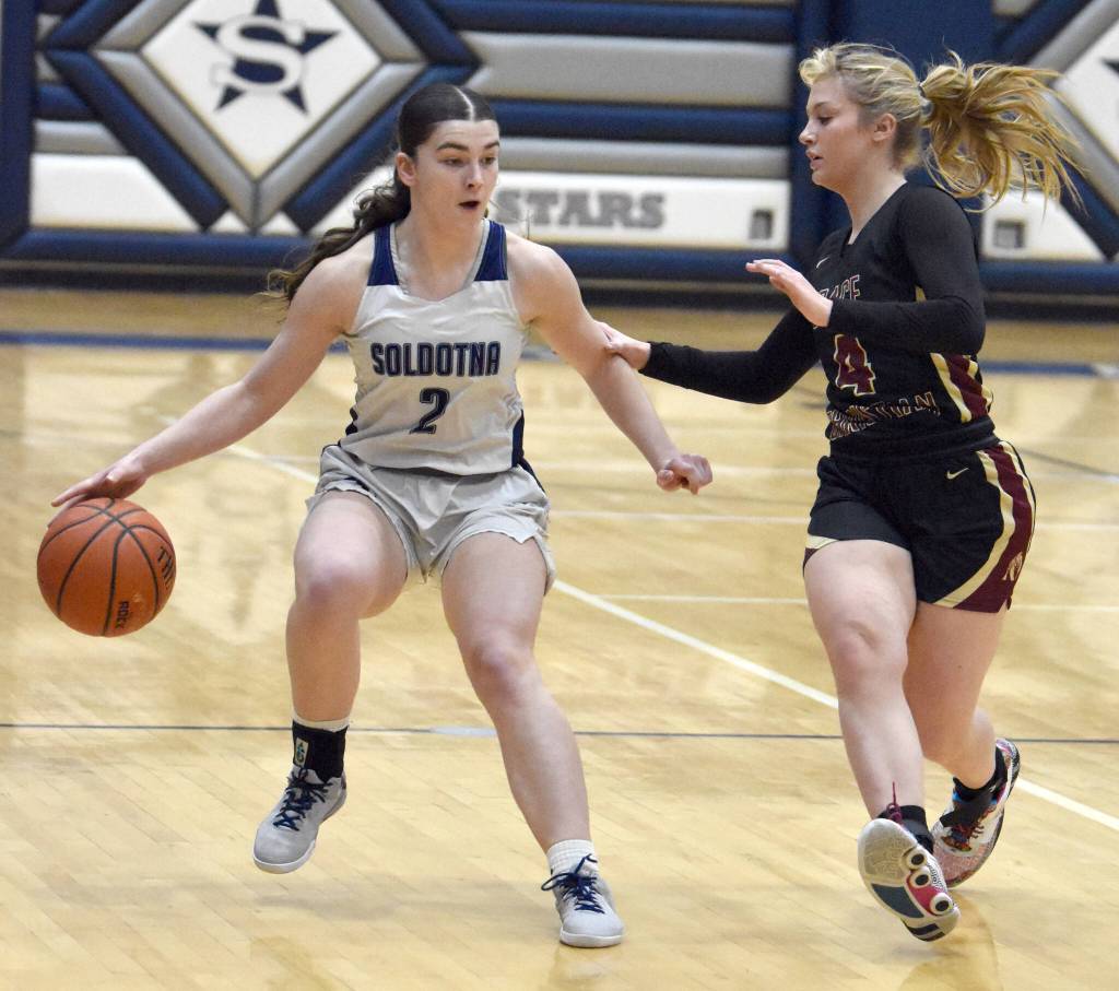 Soldotnas Anaulie Sedivy dribbles against Grace Christians Poppy Wiggers-Pidduck on Saturday, Feb. 22, 2025, at Soldotna High School in Soldotna, Alaska. (Photo by Jeff Helminiak/Peninsula Clarion)