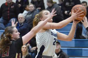 Soldotna's Hope Hillyer shoots against Grace Christian's MJ Van der horst on Saturday, Feb. 22, 2025, at Soldotna High School in Soldotna, Alaska. (Photo by Jeff Helminiak/Peninsula Clarion)