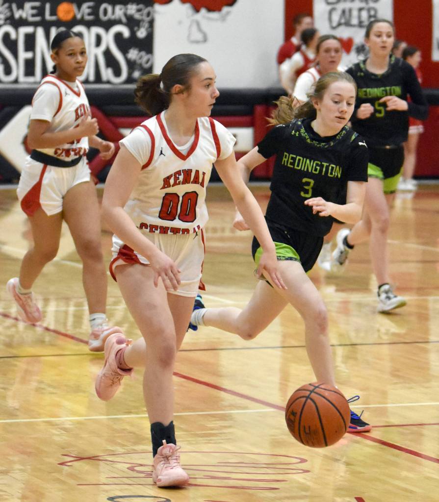 Kenai Centrals Sierra Hershberger brings the ball up against Redingtons Iselin Swalling on Thursday, February 27, 2025, at Kenai Central High School in Kenai, Alaska. (Photo by Jeff Helminiak/Peninsula Clarion)