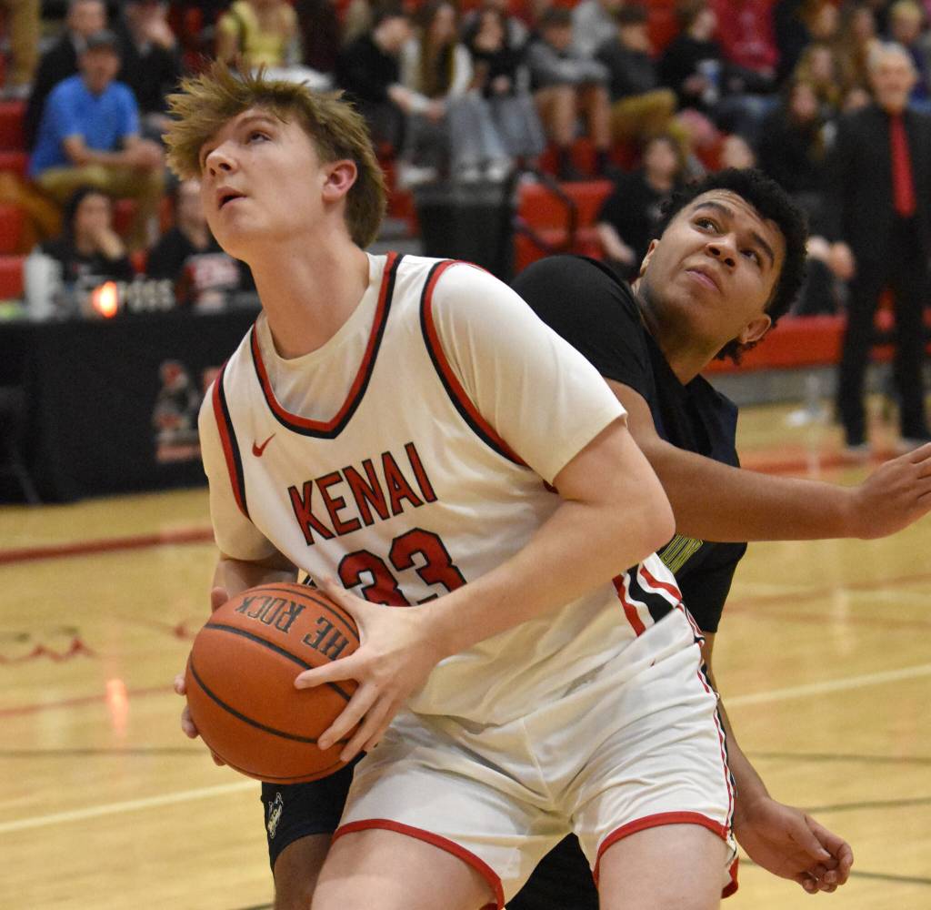 Kenai Centrals Mason Tunseth goes up for a shot against Redingtons Aiden Dobbs on Thursday, February 27, 2025, at Kenai Central High School in Kenai, Alaska. (Photo by Jeff Helminiak/Peninsula Clarion)
