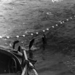 Photo courtesy of Ken Moore
In this undated photograph, Poopdeck Platt, wearing his old Stetson, watches from his fishing vessel, the Hummingbird, as the salmon begin to come aboard.