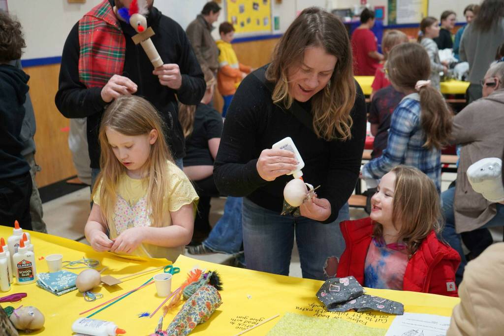Students and families create puppets during a family art night hosted by Artist in Residence Shala Dobson at Kaleidoscope School of Arts and Science in Kenai, Alaska, on Thursday, Feb. 27, 2025. (Jake Dye/Peninsula Clarion)
