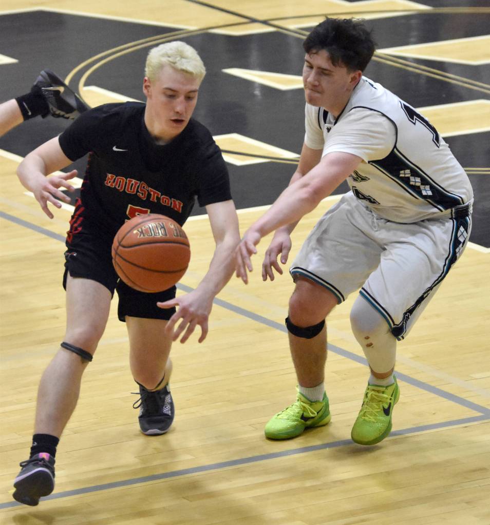 Houstons Aiden McDonell and Nikiskis Kevin Love battle for the ball Friday, February 28, 2025, at Nikiski Middle-High School in Nikiski, Alaska. (Photo by Jeff Helminiak/Peninsula Clarion)