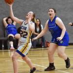 Cook Inlet Academys Beka Dillingham drives on Nanwaleks Hadassah Haskins on Saturday, March 1, 2025, at the Peninsula Conference tournament at Cook Inlet Academy just outside of Soldotna, Alaska. (Photo by Jeff Helminiak/Peninsula Clarion)