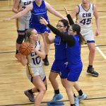 Cook Inlet Academys Kristi Stoll holds the ball under pressure from Nanwaleks Harleigh Romanoff-Moonin and Emma Tanape on Saturday, March 1, 2025, at the Peninsula Conference tournament at Cook Inlet Academy just outside of Soldotna, Alaska. (Photo by Jeff Helminiak/Peninsula Clarion)