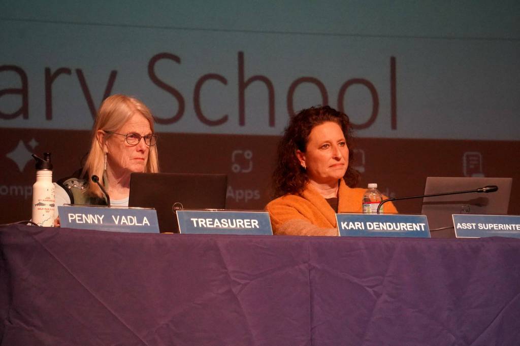 Penny Vadla and Assistant Superintendent Kari Dendurent listen to a presentation on proposed school closures during a meeting of the Kenai Peninsula Borough School Districts Board of Education in Homer, Alaska, on Monday, March 3, 2025. (Jake Dye/Peninsula Clarion)