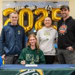 Homer senior Gracie Miotke (seated) committed to run track and field at the University of Alaska Anchorage on Wednesday, March 5, 2025, at Homer High School in Homer, Alaska. Behind Miotke are Homer head coach Bob Ostrom; mother, Amanda Miotke; and father, Dan Miotke. (Photo provided)