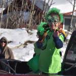 A child waves from the back of a truck as the 32nd annual Sweeneys St. Patricks Day Parade proceeds down Fireweed Street in Soldotna, Alaska on Friday, March 17, 2023. (Jake Dye/Peninsula Clarion)