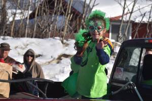 A child waves from the back of a truck as the 32nd annual Sweeneys St. Patricks Day Parade proceeds down Fireweed Street in Soldotna, Alaska on Friday, March 17, 2023. (Jake Dye/Peninsula Clarion)