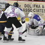 Kenai River Brown Bears goaltender Mitchell Mccusker makes a save in front of Logan Ganz of the Springfield (Illinois) Jr. Blues and Gavin Jensen of the Bears on Thursday, March 6, 2025, at the Soldotna Regional Sports Complex in Soldotna, Alaska. (Photo by Jeff Helminiak/Peninsula Clarion)