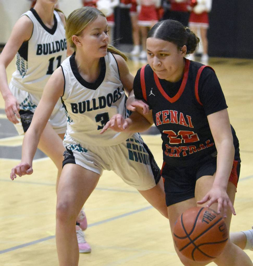 Kenai Centrals Bryleigh Williams drives on Abby White on Friday, March 7, 2025, at the Peninsula Conference tournament at Nikiski Middle-High School in Nikiski, Alaska. (Photo by Jeff Helminiak/Peninsula Clarion)