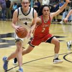 Homers Einar Pederson drives on Kenai Centrals Garrett McCanna on Saturday, March 8, 2025, at the Peninsula Conference tournament at Nikiski Middle-High School in Nikiski, Alaska. (Photo by Jeff Helminiak/Peninsula Clarion)