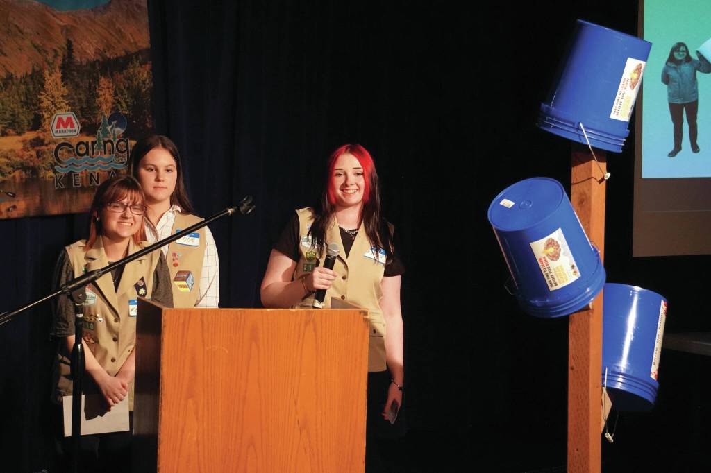 Girl Scout Troop 210, which includes Caitlyn Eskelin, Emma Hindman, Kadie Newkirk and Lyberty Stockman, present their Bucket Trees to a panel of judges in the 34th Annual Caring for the Kenai Competition at Kenai Central High School in Kenai, Alaska, on Thursday, April 18, 2024. (Jake Dye/Peninsula Clarion)