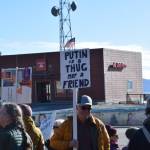 A community member holds up a protest sign during the Stand for Democracy Rally on International Womens Day, March 8, 2025, at WKFL Park in Homer, Alaska. (Chloe Pleznac/Homer News)