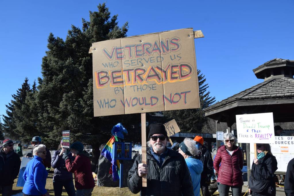Robert Walsh stands with a protest sign at the Stand for Democracy Rally on International Womens Day, March 8, 2025, at WKFL Park in Homer, Alaska. (Chloe Pleznac/Homer News)
