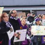 Protestors gather at the Alaska State Capitol on Wednesday, March 12, 2025. Jamie Liston holds a sign that says family is everything. (Jasz Garrett / Juneau Empire)