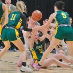 Sewards Grace Fleming (20), Addison Lemme (11) and Lia Shank (5) battle for a loose ball with Unalakleets Ourea Busk and Izabella Eller (25) during the Seahawks 32-29 semifinal win Friday in the 2025 ASAA March Madness Alaska 2A State Basketball Championships at Anchorages Alaska Airlines Center on Friday, March 14, 2025. (Klas Stolpe / Juneau Empire)