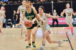 Seward's Natalie Sieminski (15) and Unalakleet's Lizabeth Ivanoff (2) go for a loose ball during the Seahawks' 32-29 semifinal win Friday, March 14, 2025, in the 2025 ASAA March Madness Alaska 2A State Basketball Championships at Anchorage's Alaska Airlines Center. (Klas Stolpe / Juneau Empire)