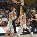 Cook Inlet Academys Alek McGarry slices between Shaktooliks Devin Rock and Austin Rock at the Class 1A boys state championship game Saturday, March 15, 2025, at the Alaska Airlines Center in Anchorage, Alaska. (Photo by Jeff Helminiak/Peninsula Clarion)