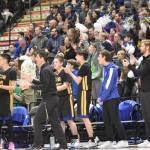 Cook Inlet Academy head coach Ben McGarry, the team and fans cheer at the Class 1A boys state championship game Saturday, March 15, 2025, at the Alaska Airlines Center in Anchorage, Alaska. (Photo by Jeff Helminiak/Peninsula Clarion)