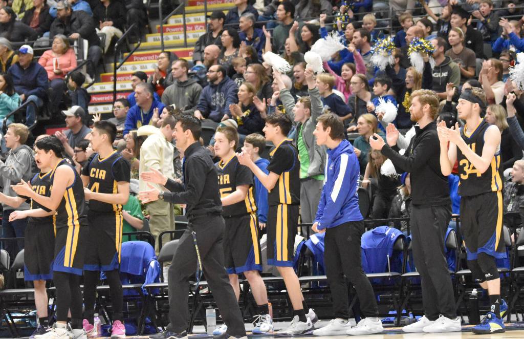 Cook Inlet Academy head coach Ben McGarry, the team and fans cheer at the Class 1A boys state championship game Saturday, March 15, 2025, at the Alaska Airlines Center in Anchorage, Alaska. (Photo by Jeff Helminiak/Peninsula Clarion)