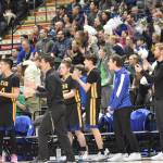 Cook Inlet Academy head coach Ben McGarry, the team and fans cheer at the Class 1A boys state championship game Saturday, March 15, 2025, at the Alaska Airlines Center in Anchorage, Alaska. (Photo by Jeff Helminiak/Peninsula Clarion)