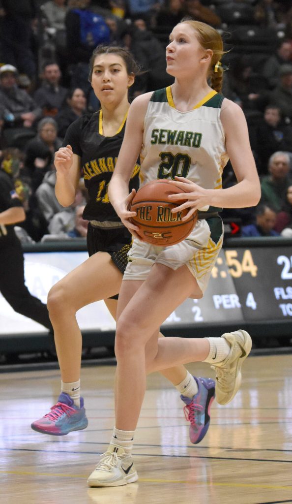Sewards Grace Fleming drives on Glennallens Cheyenne Fields at the Class 2A girls state championship game Saturday, March 15, 2025, at the Alaska Airlines Center in Anchorage, Alaska. (Photo by Jeff Helminiak/Peninsula Clarion)