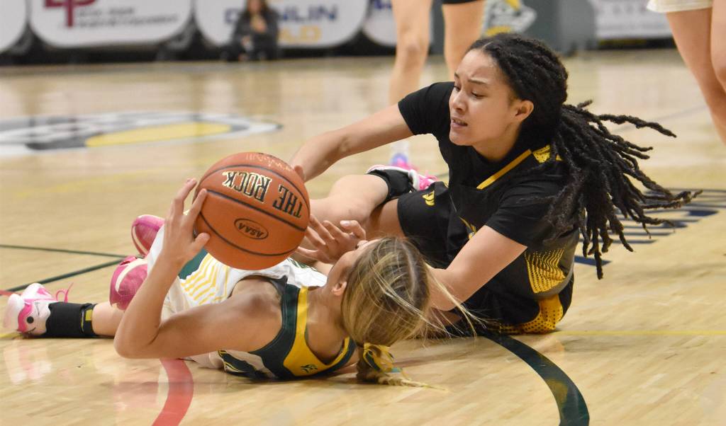 Sewards Ava Jagielski and Glennallens Alianna Stone battle for the ball at the Class 2A girls state championship game Saturday, March 15, 2025, at the Alaska Airlines Center in Anchorage, Alaska. (Photo by Jeff Helminiak/Peninsula Clarion)