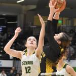 Sewards Mikinley Williams battles Glennallens Koiana Cooley for the ball at the Class 2A girls state championship game Saturday, March 15, 2025, at the Alaska Airlines Center in Anchorage, Alaska. (Photo by Jeff Helminiak/Peninsula Clarion)