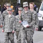 A youth participating in the Civil Air Patrol contingent passes out candy along Fireweed Street during the Sweeneys St. Patricks Day Parade, Monday, March 17, 2025, in Soldotna, Alaska. (Photo by Erin Thompson/Peninsula Clarion)