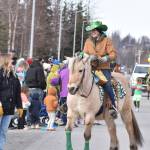 A horse and rider travel along Fireweed Street during the Sweeneys St. Patricks Day Parade, Monday, March 17, 2025, in Soldotna, Alaska. (Photo by Erin Thompson/Peninsula Clarion)