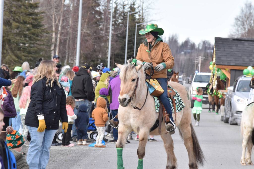 A horse and rider travel along Fireweed Street during the Sweeneys St. Patricks Day Parade, Monday, March 17, 2025, in Soldotna, Alaska. (Photo by Erin Thompson/Peninsula Clarion)