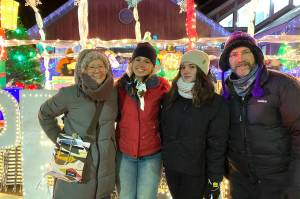 Cemre Akgul of Turkey, center left, and Flokarta Hoxha of Kosovo, center right, stand for a photo with members of their host family, Casady and Patrick Herding, at the Kenai Chamber of Commerce and Visitors Center in Kenai, Alaska, on Friday, Nov. 29, 2024. (Photo provided by Patrick Herding)